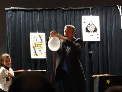 Spectacle de magie devant un groupe d'enfants assis
